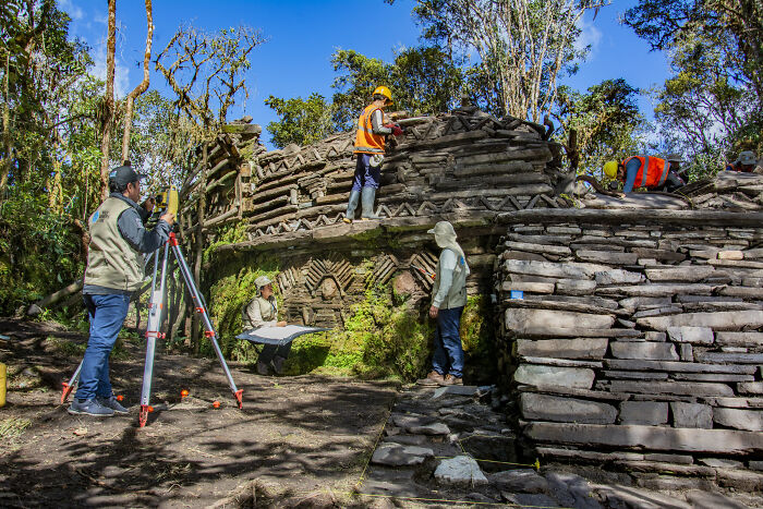 Archaeologists excavating stone structures linked to a mysterious ancient civilization in a forested archaeological site. - 7
