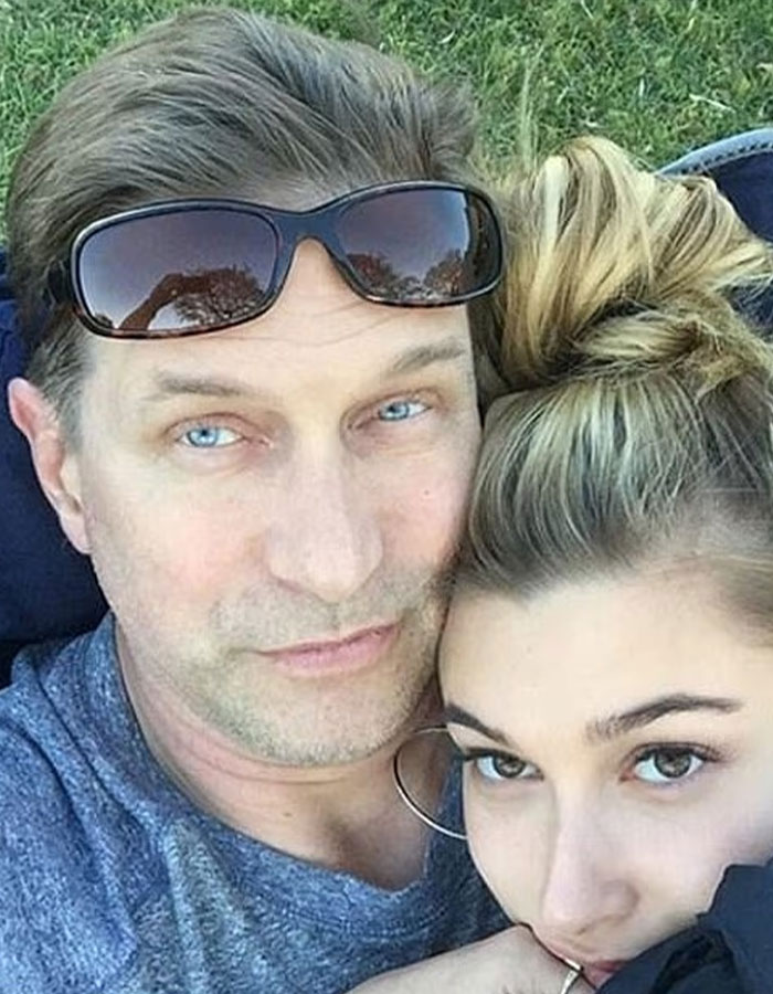 Stephen Baldwin and Hailey Bieber close together outdoors, capturing a personal family moment amid Rhode sale news.