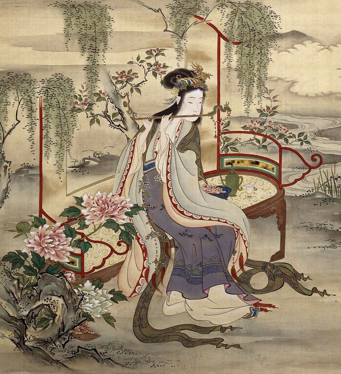 Traditional painting of a historical courtesan playing a flute, surrounded by flowers and elegant furnishings.