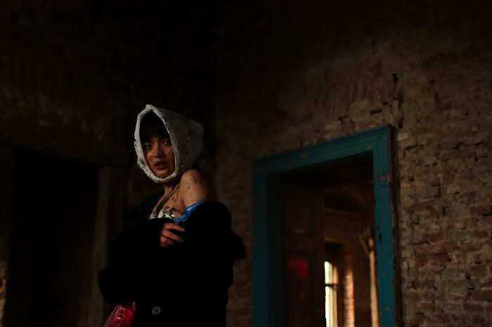 A Veiled Witness In The Theater Of Collapse, Dressed For The Aftermath