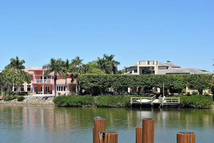 Waterfront homes with lush greenery and palm trees, showcasing the best places to live in the USA for settling down.