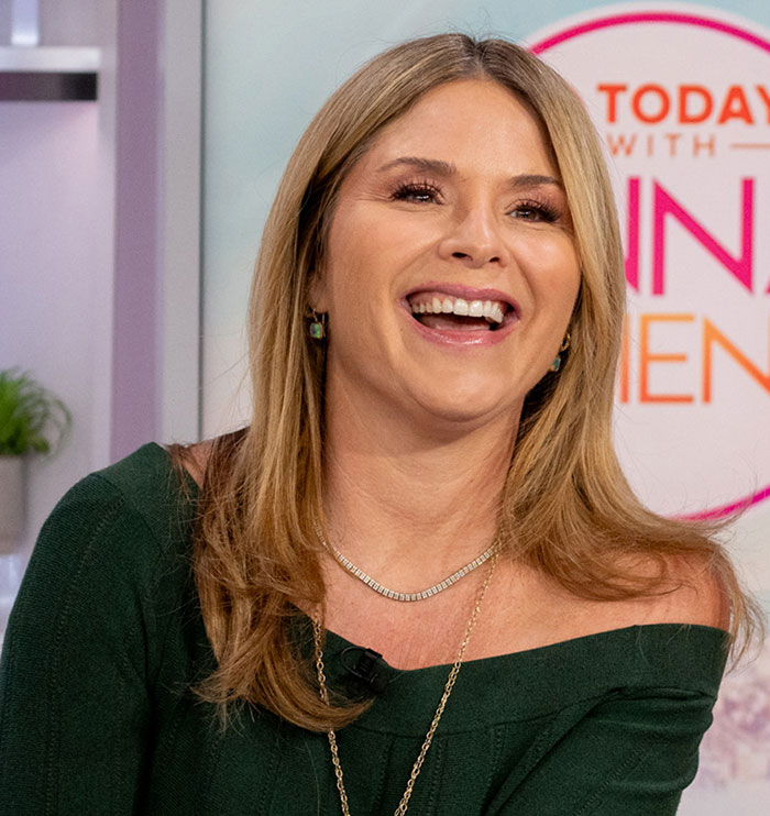 A smiling woman in a green off-shoulder top during a daytime talk show about celebrity criticism of Bezos wedding.
