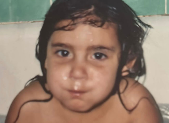 Young child with wet hair, possibly in a bathtub, related to update on 7-Eleven employee passing, police statement included