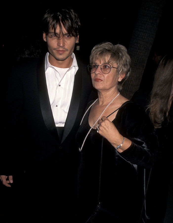 Johnny Depp with his mother at a formal event, reflecting on his dark childhood with a violent mom.