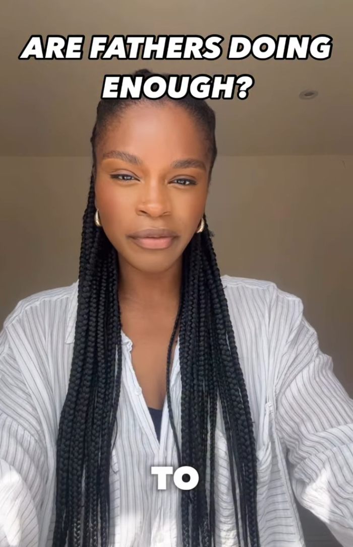 Woman with long braids wearing a striped shirt, discussing the 2YO toddler realizing she&rsquo;s Black after daycare experience.