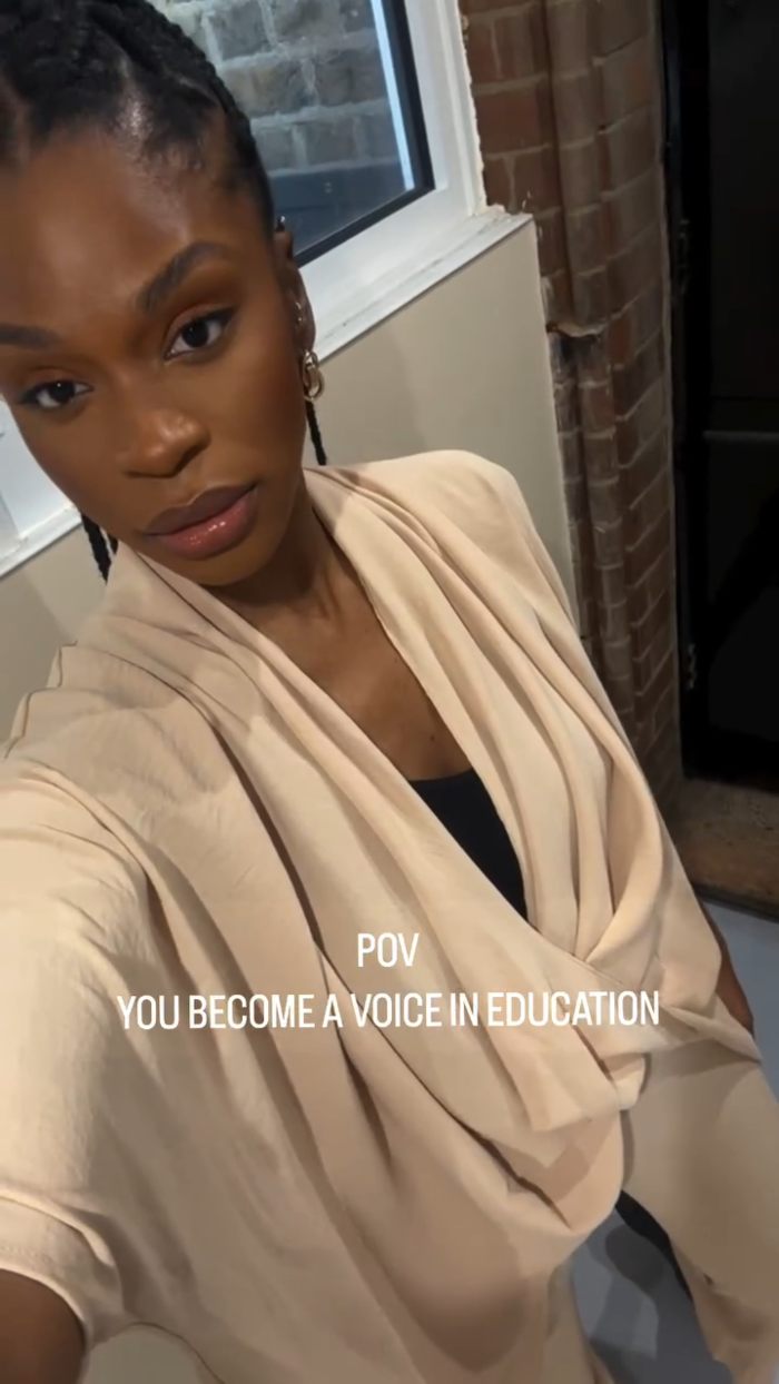 African American woman wearing beige clothing, standing indoors near a window, representing toddler realizing she&rsquo;s Black.