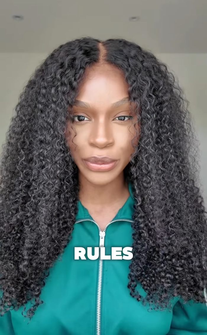 Woman with long curly hair in a green jacket, discussing a 2YO toddler realizing she&rsquo;s Black after daycare experience.