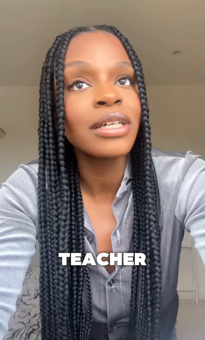 Woman with long braided hair speaking in a video about 2YO toddler realizing she&rsquo;s Black after going to daycare.