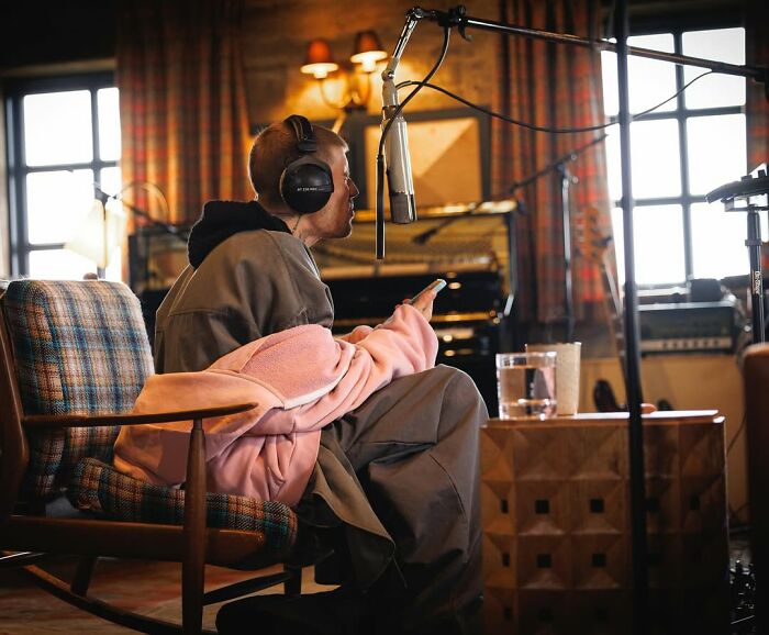 Justin Bieber in a recording studio, wearing headphones and opening up about marriage and mental struggles for new album.