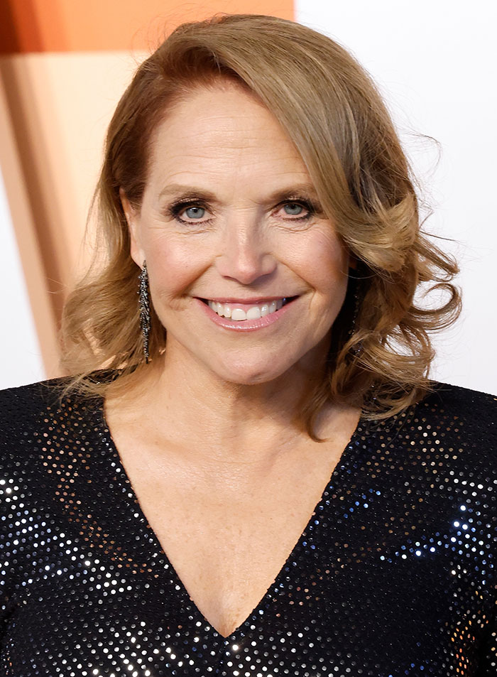 Celebrity in a black sequined dress smiling at an event related to Jeff Bezos and Lauren Sánchez wedding criticism.