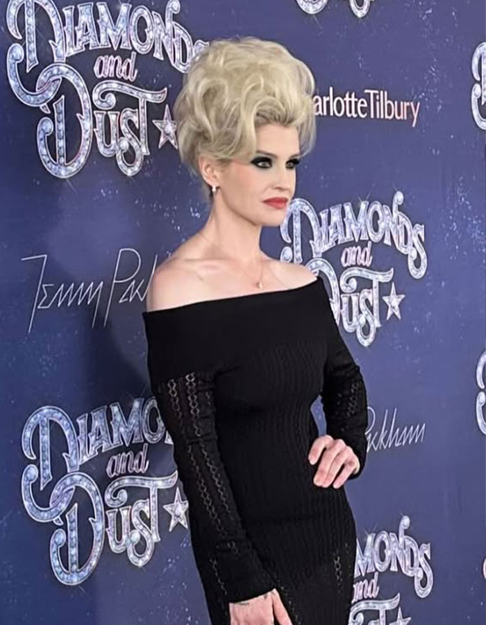 Kelly Osbourne stuns fans with 90s glam fashion look, featuring bold makeup and a sleek black off-shoulder dress. Kelly Osbourne stuns fans with 90s glam fashion look, featuring bold makeup and a sleek black off-shoulder dress.