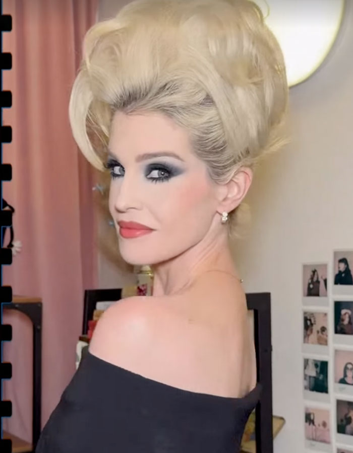 Kelly Osbourne in 90s glam fashion with voluminous hair and dramatic makeup, showcasing a bold retro style. Kelly Osbourne in 90s glam fashion with voluminous hair and dramatic makeup, showcasing a bold retro style.