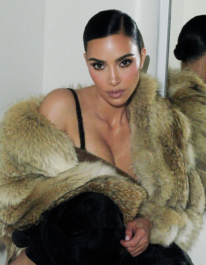 Kim Kardashian wearing a controversial fur coat, posing indoors with sleek hairstyle and bold makeup. Kim Kardashian wearing a controversial fur coat, posing indoors with sleek hairstyle and bold makeup.