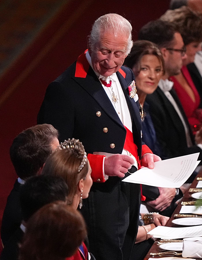King Charles speaking at Windsor Castle banquet, praising William while Prince Harry appears to be snubbed during the event. King Charles speaking at Windsor Castle banquet, praising William while Prince Harry appears to be snubbed during the event.