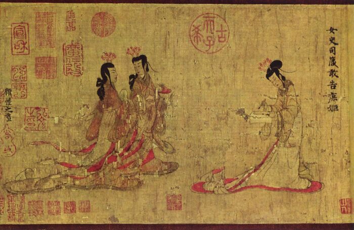 Ancient Asian artwork depicting three figures in traditional dress, one holding an object, part of foreign artifacts in the British Museum.