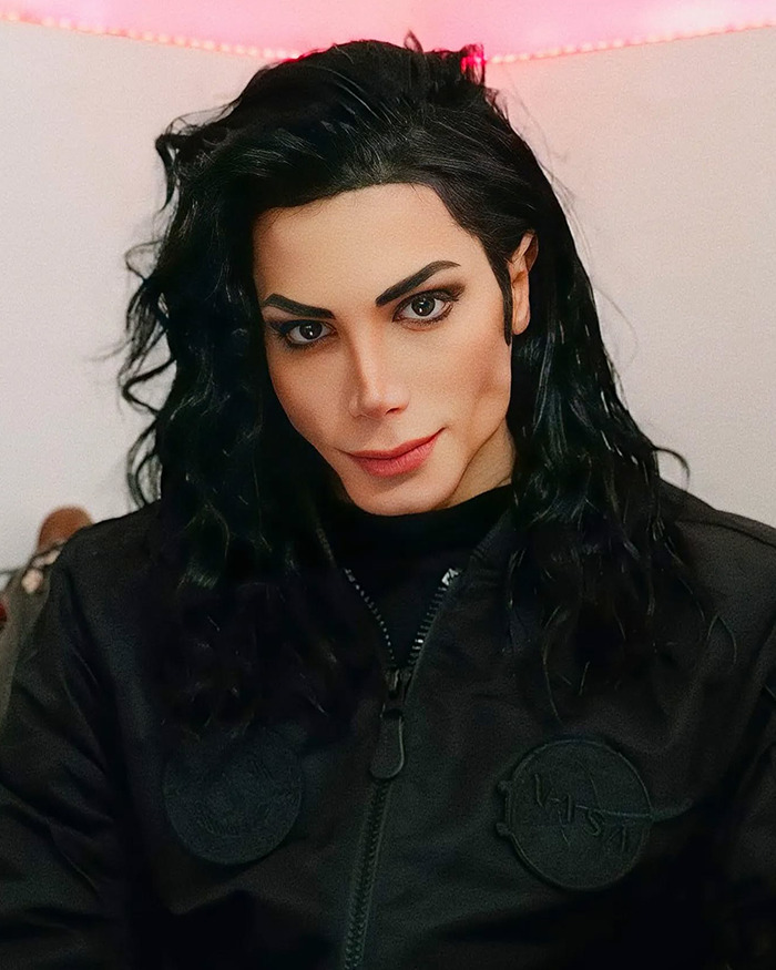 Person with long black hair and sharp facial features posing indoors, showcasing extreme plastic surgery transformation.