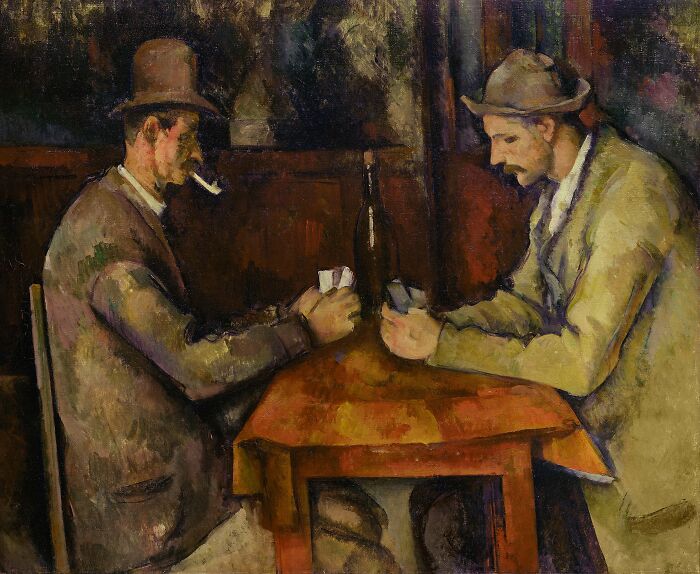Two men wearing hats play cards at a wooden table in a dimly lit room, a collectible artwork sold for high value.