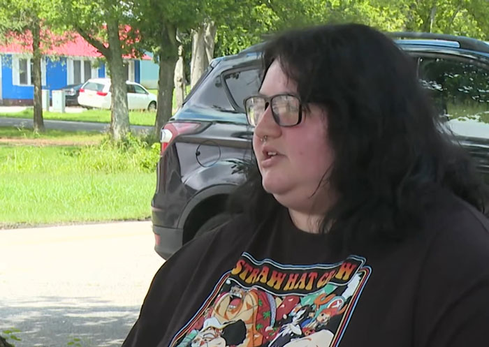 Teen with glasses and dark hair speaking outdoors near parked cars, related to incident of teen zapped by lightning inside house using phone. Teen with glasses and dark hair speaking outdoors near parked cars, related to incident of teen zapped by lightning inside house using phone.