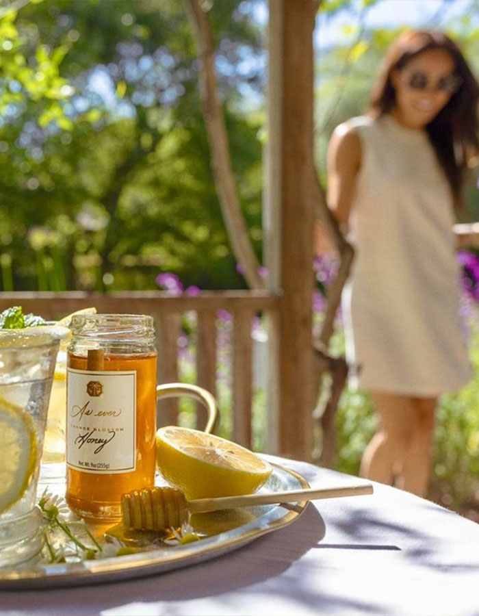 Jar of As Ever honey with lemon and honey dipper on a tray outdoors, hinting at Meghan Markle website glitch and refunds.