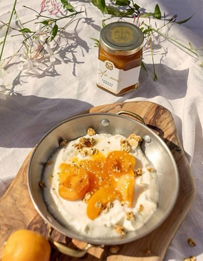 Jar of As Ever honey with yogurt and apricot dish on wooden board, illustrating Meghan Markle website glitch refunds.