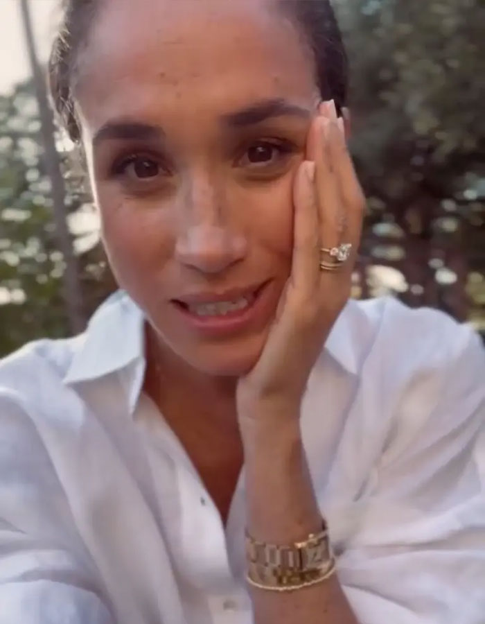 Meghan Markle shown outdoors, looking concerned while addressing website glitch affecting shoppers and refunds.