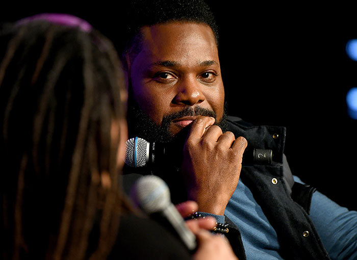 Man holding microphone during interview, related to second victim revealed in tragic accident involving Malcolm-Jamal Warner. - 2