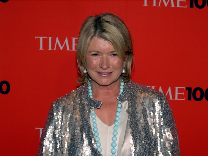 Woman wearing a silver sequin jacket and turquoise necklace at a TIME 100 event symbolizing from poverty to super wealthy success.