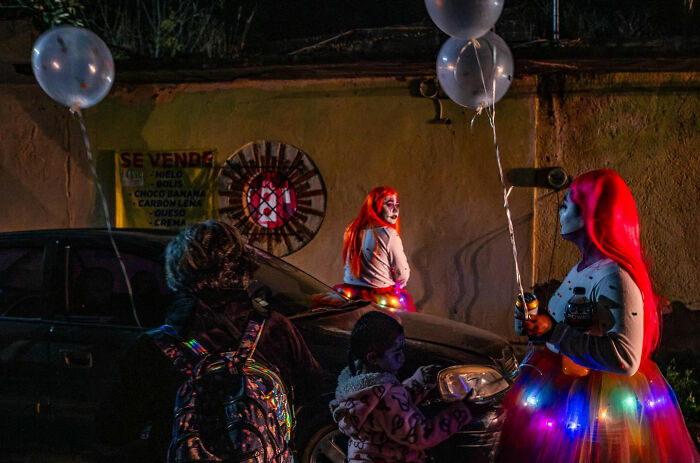 Street moments captured at night showing colorful costumes and joyful everyday life on the city streets.