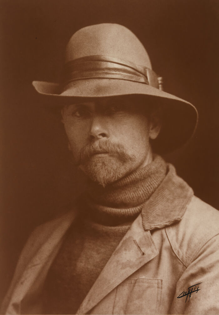 Portrait of Edward S. Curtis in a hat and jacket, showcasing powerful Edward S. Curtis photos preserving Native American history.