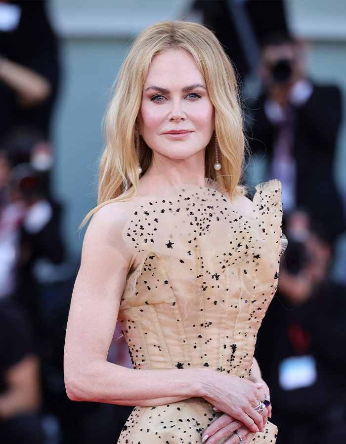 Nicole Kidman embracing natural curls with a stunning elegant look at a high-profile red carpet event.