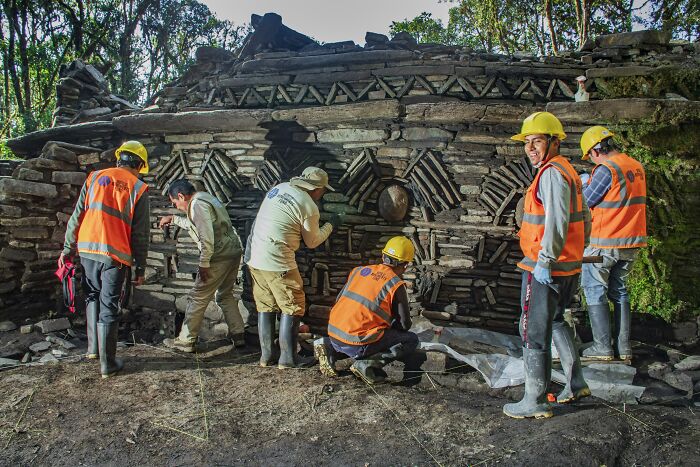 Archaeologists in helmets and vests excavate and study ancient stone structures linked to a mysterious civilization. - 8