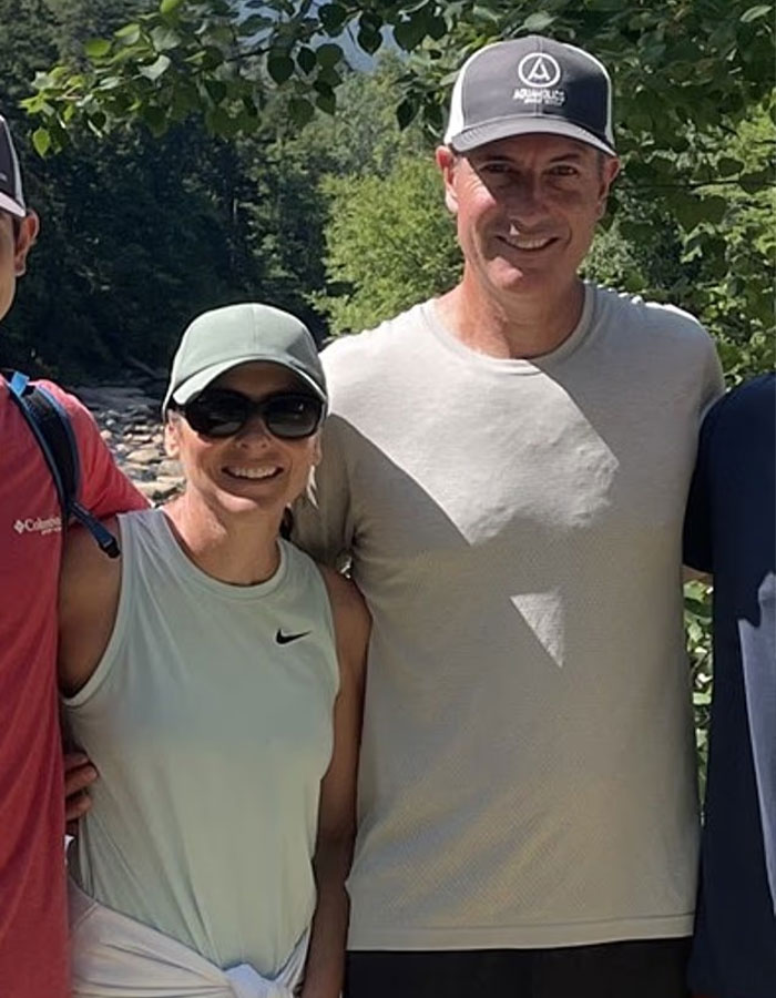 Group of people outdoors smiling, capturing a casual moment unrelated to baseball mascot or CEO scandal.