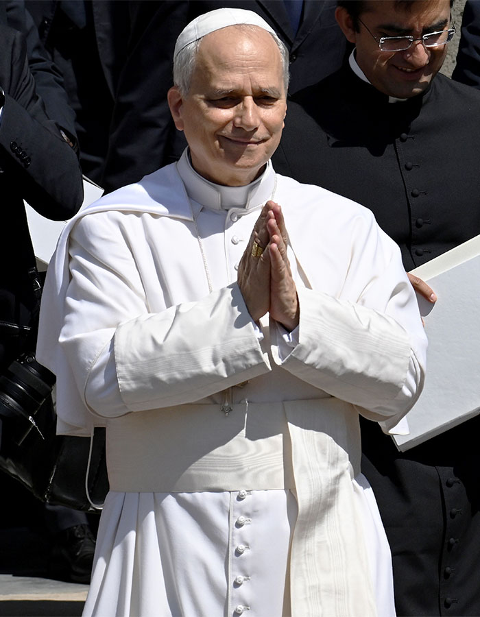 Doctor involved in Pope Leo’s miracle, dressed in white papal robes, making a gesture with hands together outdoors. - 1