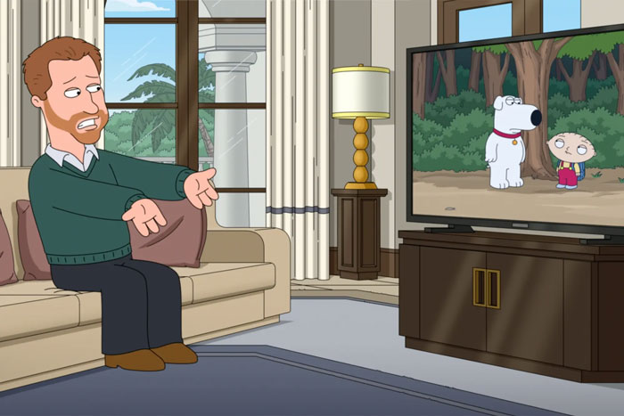 Animated character representing Prince Harry sitting on a couch reacting to Family Guy episode featuring Brian and Stewie.