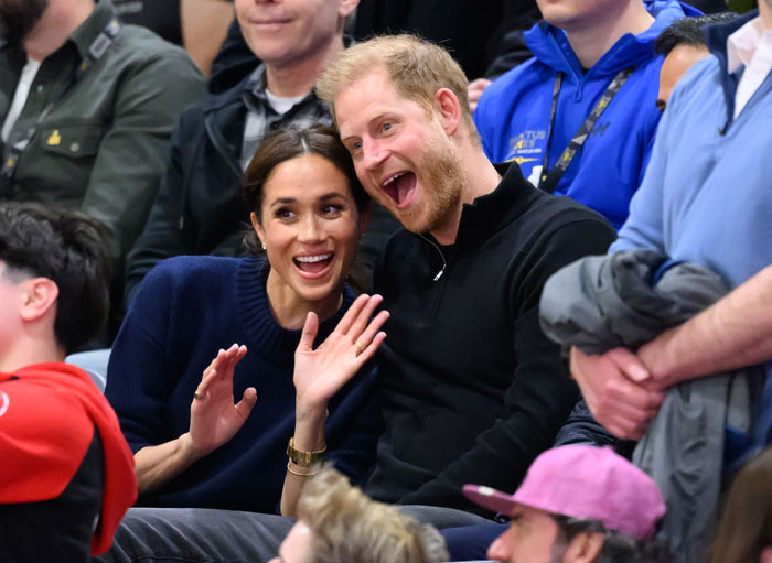Meghan Markle and Prince Harry smiling and waving in a crowd at an event, linked to Family Guy trolling keywords.