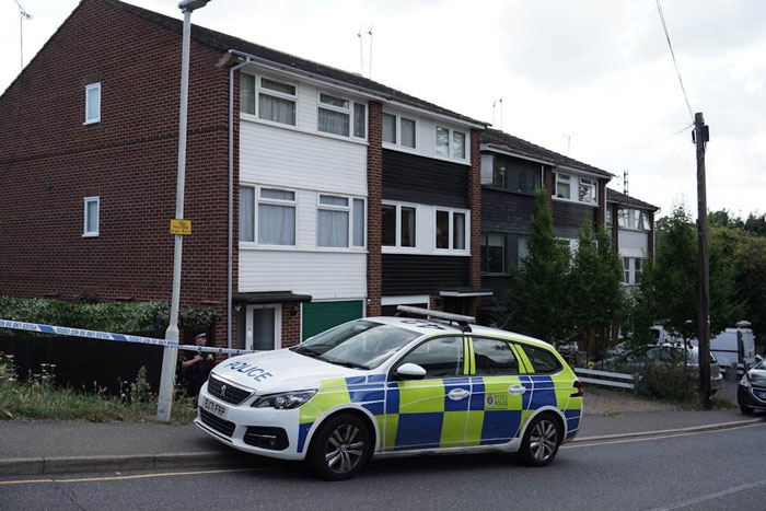 Police car parked outside a residential house involved in a documentary about a woman who lived with deceased parents. - 5