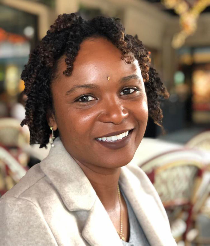 Portrait of a woman smiling indoors, related to official sparks outrage over flood-stricken Camp Mystic whites-only claim.