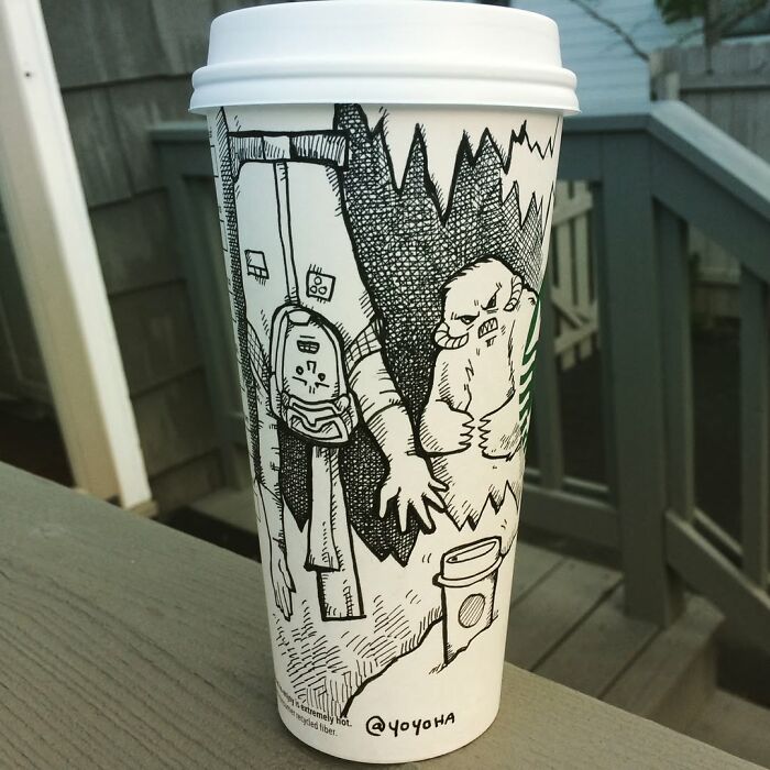 Coffee cup decorated with a hilarious and relatable cartoon drawing of creatures emerging from a dark cave.