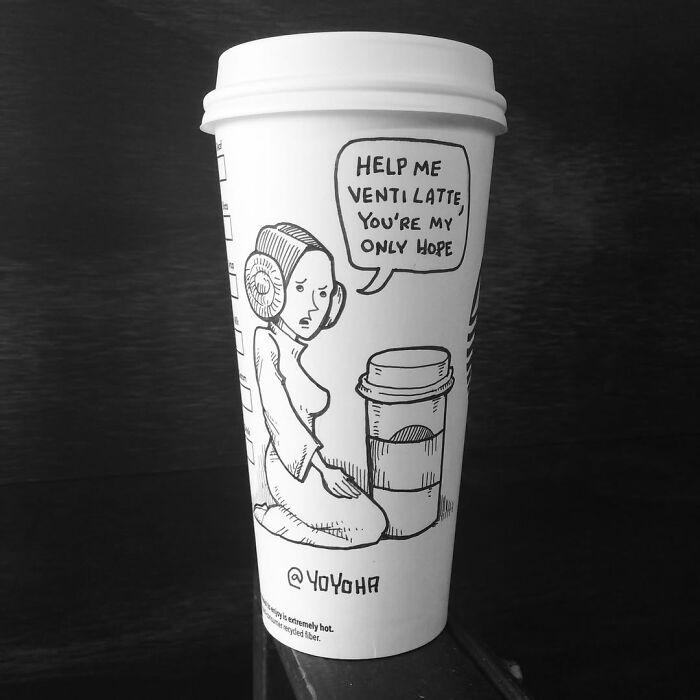 Coffee cup with a relatable cartoon drawing of a person asking for help, showcasing artist's humor in coffee cup art.