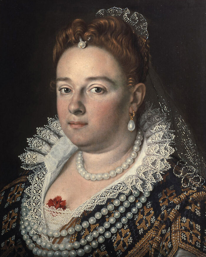 Portrait of a historical courtesan wearing ornate lace and pearl jewelry, symbolizing power and influence in history.