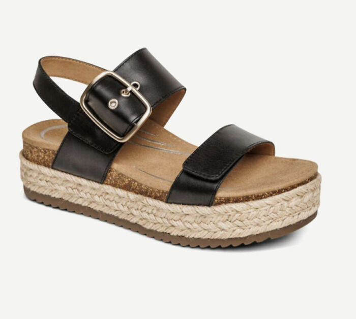 Black platform sandal with buckle strap and woven sole, a stylish comfortable pick for sandal season in Europe. - 8