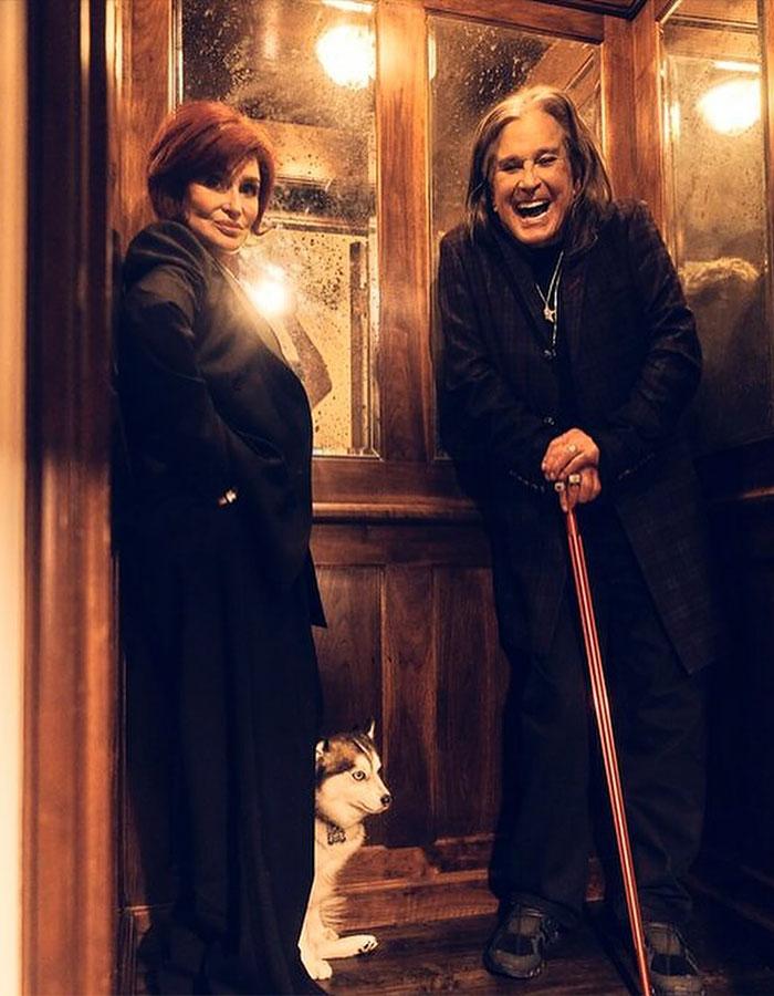 Sharon Osbourne and Ozzy Osbourne smiling indoors with a small dog, capturing a moment before his passing. - 5