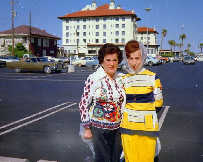 Two women in vintage 1970s clothing posing outdoors in a Florida parking lot, symbolizing women breaking barriers.