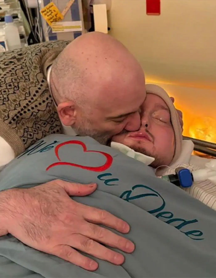 Man kissing the sleeping prince of Saudi Arabia, who is in a hospital bed covered with a blanket showing love and care. Man kissing the sleeping prince of Saudi Arabia, who is in a hospital bed covered with a blanket showing love and care.