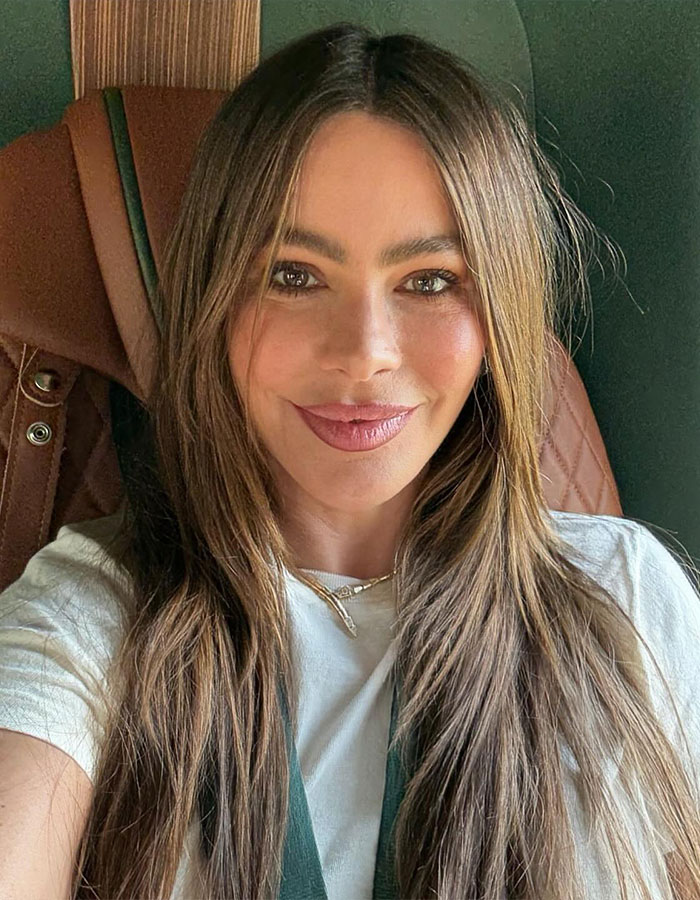Sofía Vergara smiling with long hair and natural makeup in a casual setting, showcasing her effortless beauty and charm. Sofía Vergara smiling with long hair and natural makeup in a casual setting, showcasing her effortless beauty and charm.