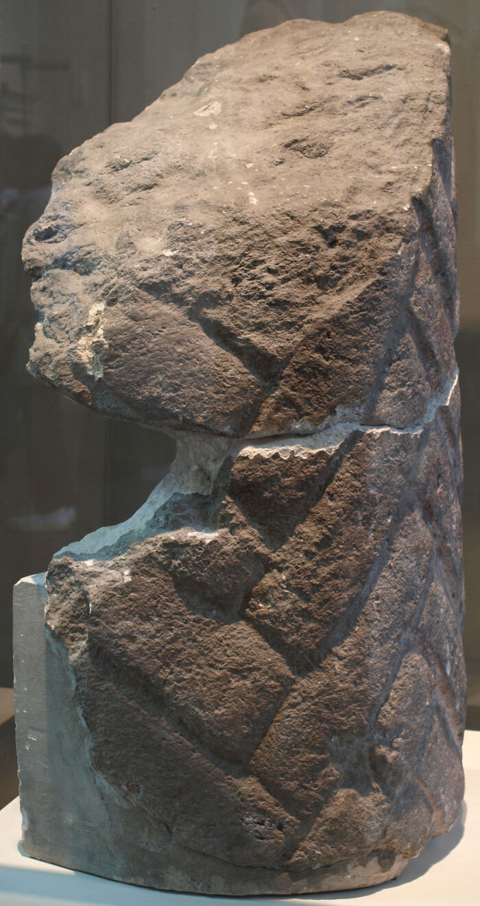 Ancient foreign artifact with carved geometric patterns displayed in the British Museum collection.