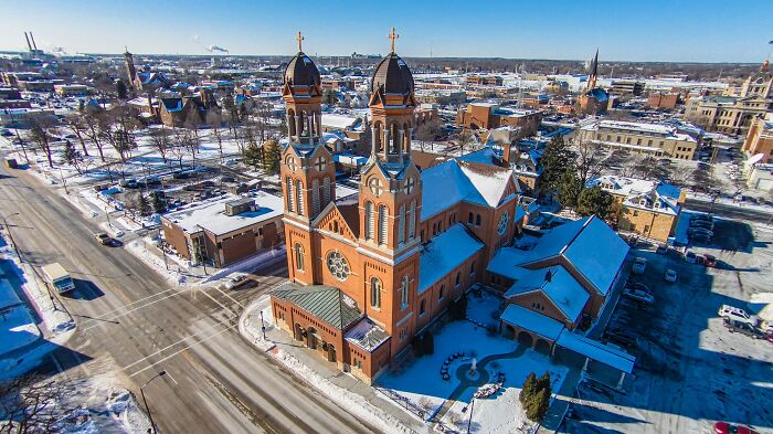 Aerial view of a snowy town with a large church in the foreground, showcasing one of the best places to live in the USA.