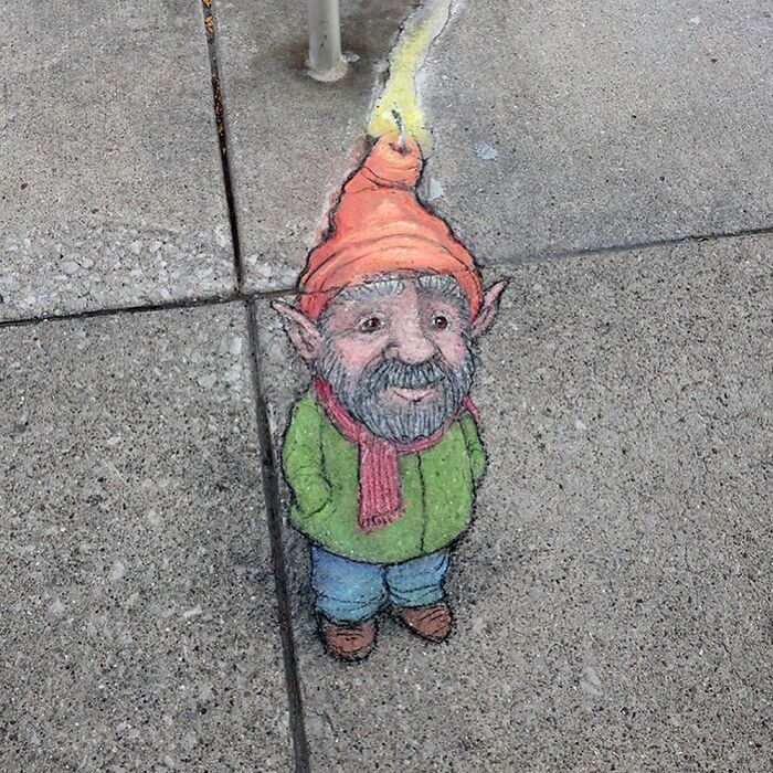Chalk drawing of a whimsical gnome on a sidewalk, part of David Zinn's magical sidewalk art creations.