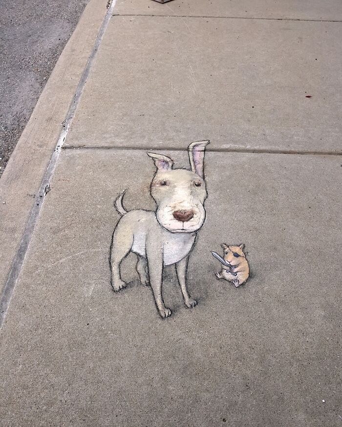Chalk drawing by David Zinn on sidewalk featuring a dog and a small creature holding a sword in magical style.