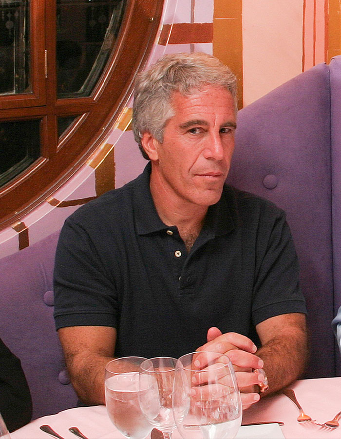 Man sitting at a table with glasses, related to conspiracy theories about Epstein list and Stephen King topics. - 3